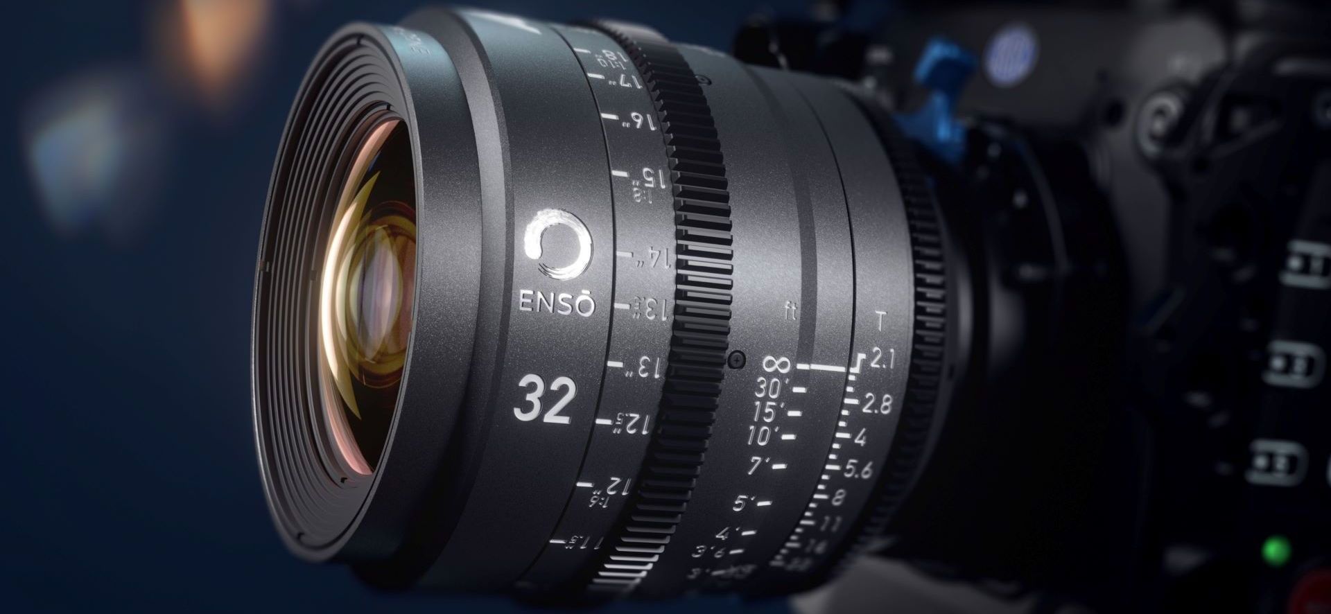 Close-up of a black camera lens with focus and distance markings.