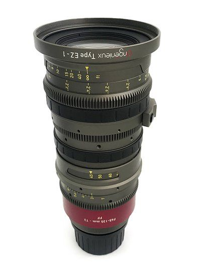 A silver and black cinema lens, labeled 