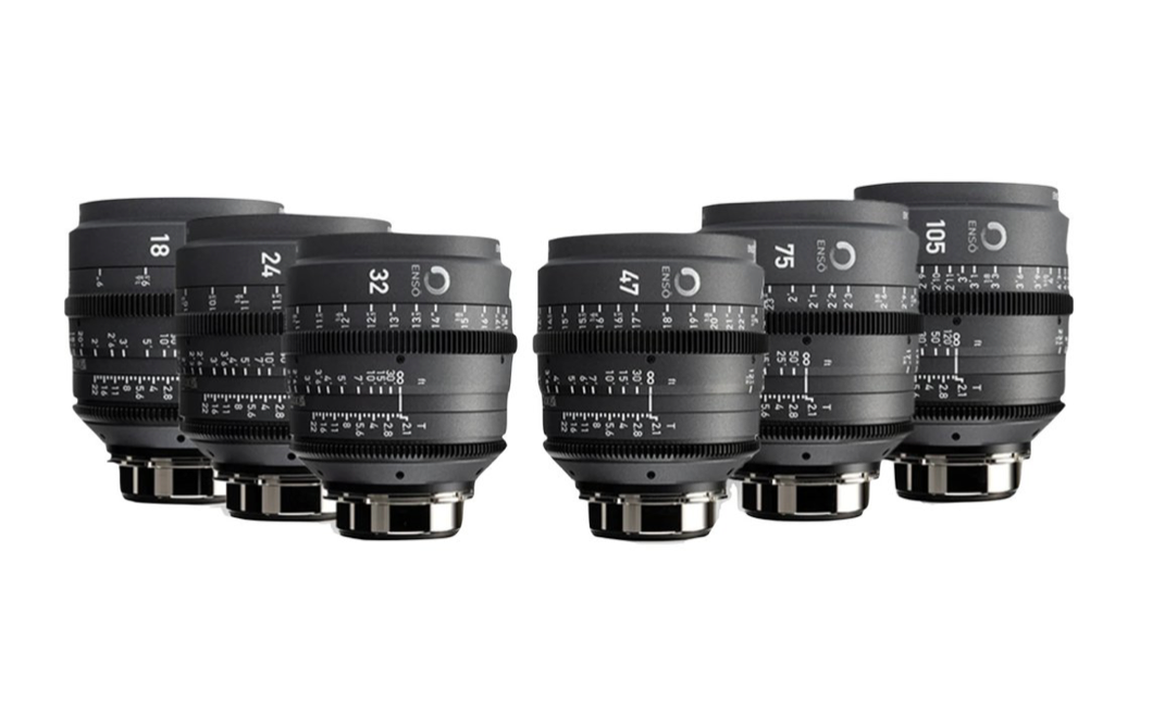 A collection of seven black camera lenses, arranged in a semi-circle.