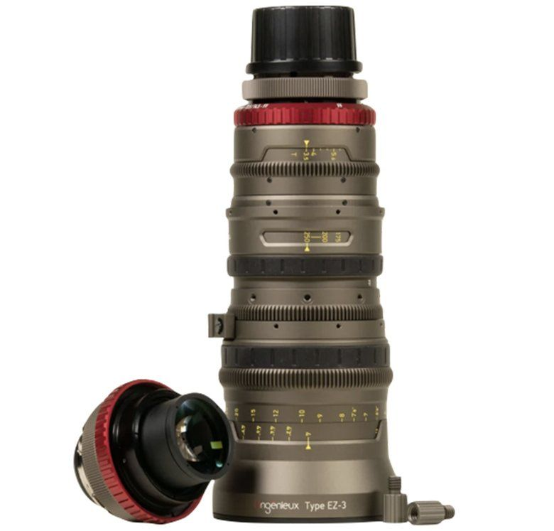 A large, metallic-gray camera lens with red accents, lens cap detached.