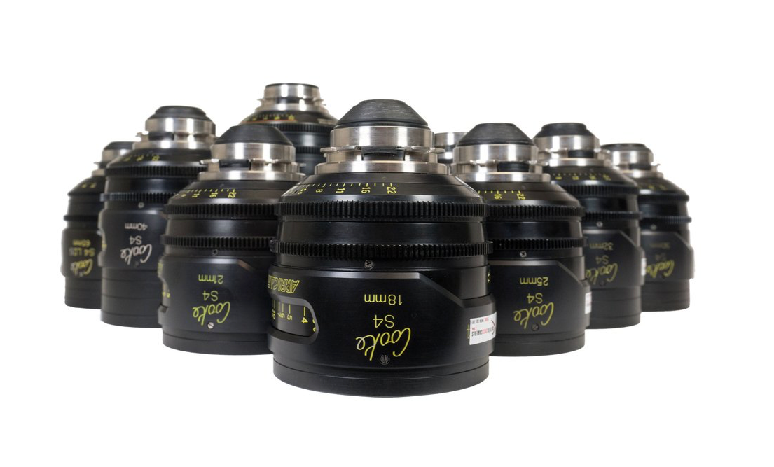 Black camera lenses with silver tops, grouped together.