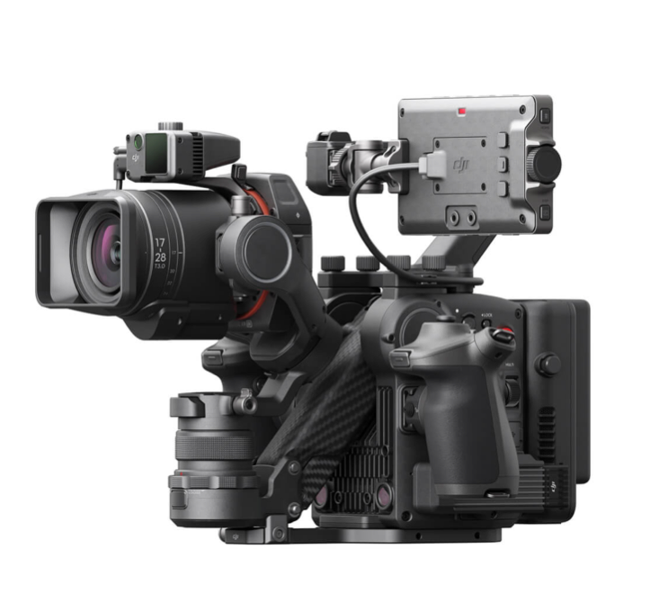 Black professional video camera with lens, attached monitor, and various accessories.