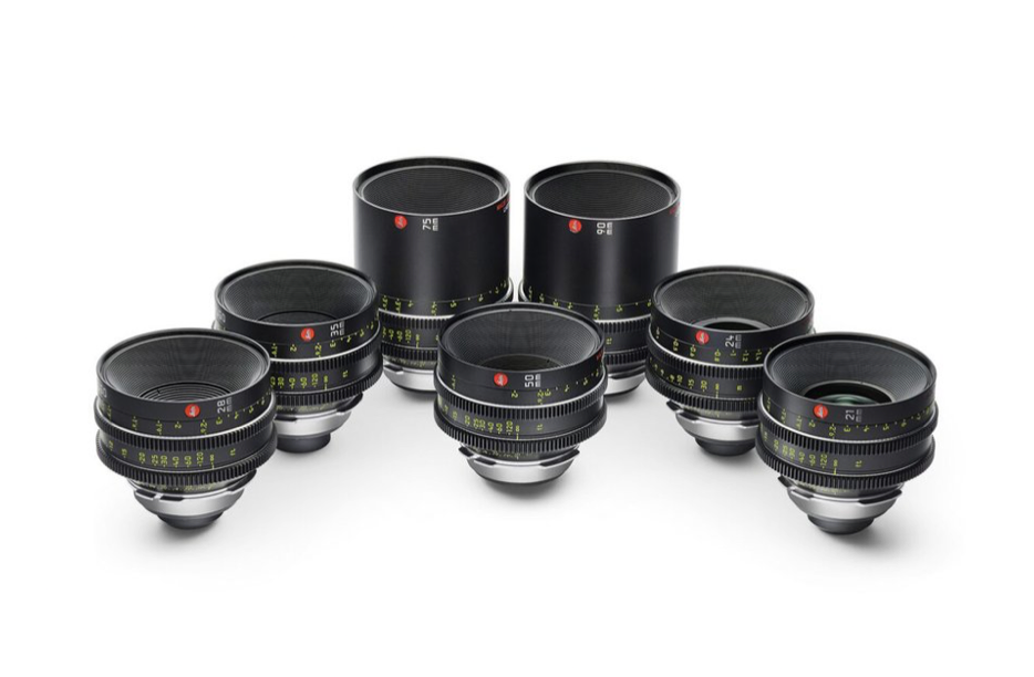 Seven black camera lenses arranged on a white background.