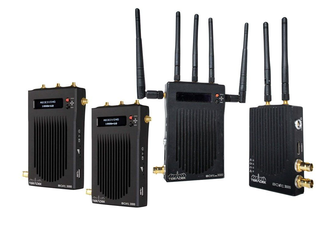 Four black wireless video transmitters and receivers with antennas.
