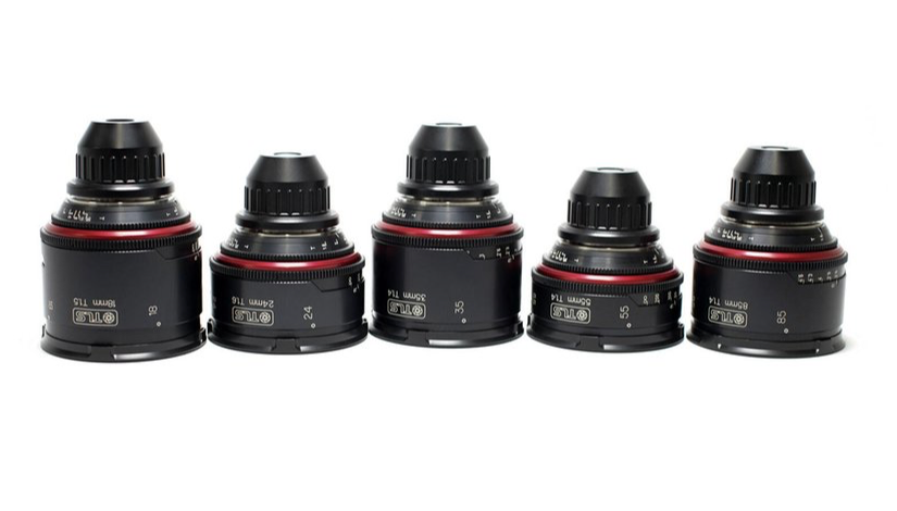 Five black cinema lenses lined up, with red accent rings, against a white background.
