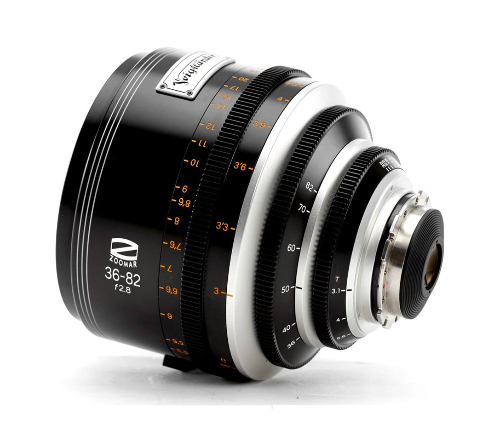 Black and silver zoom lens, angled on a white surface, with focal lengths and markings visible.