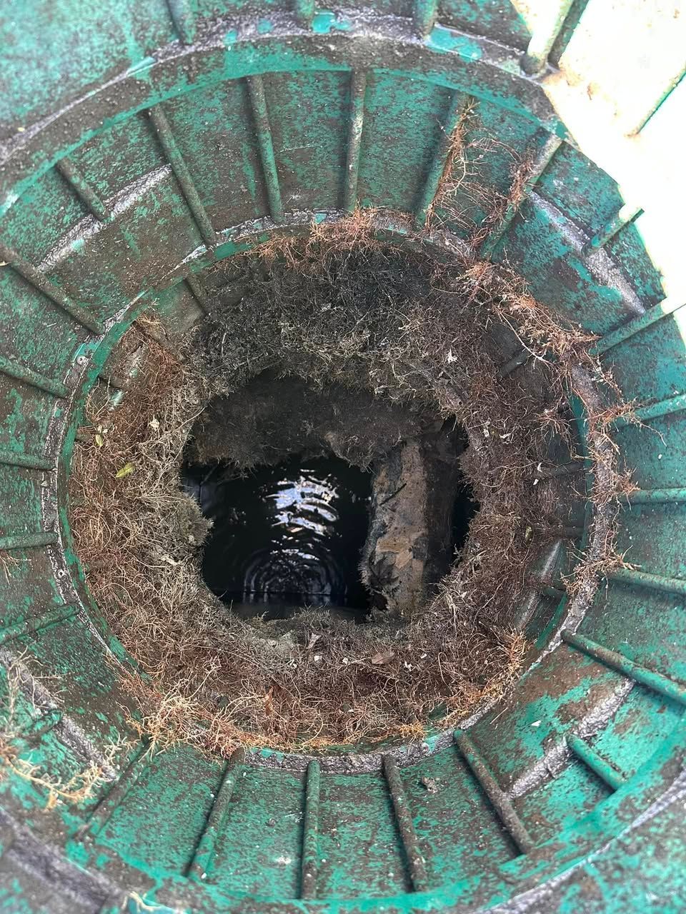 A septic manhole cover with a hole in the middle of it in Southern MD.