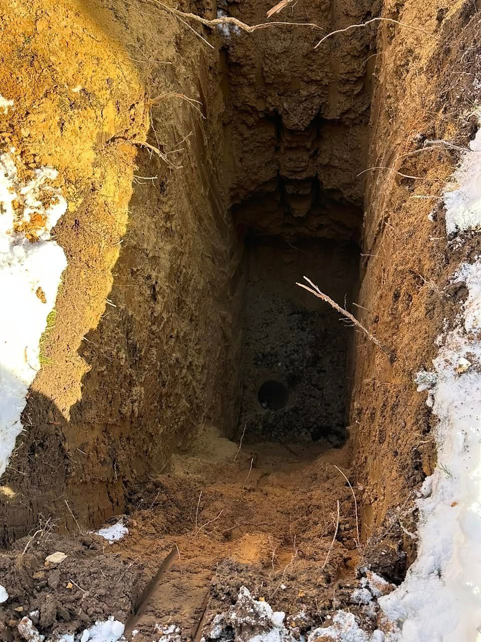 A hole in the ground filled with dirt and snow in Maryland.