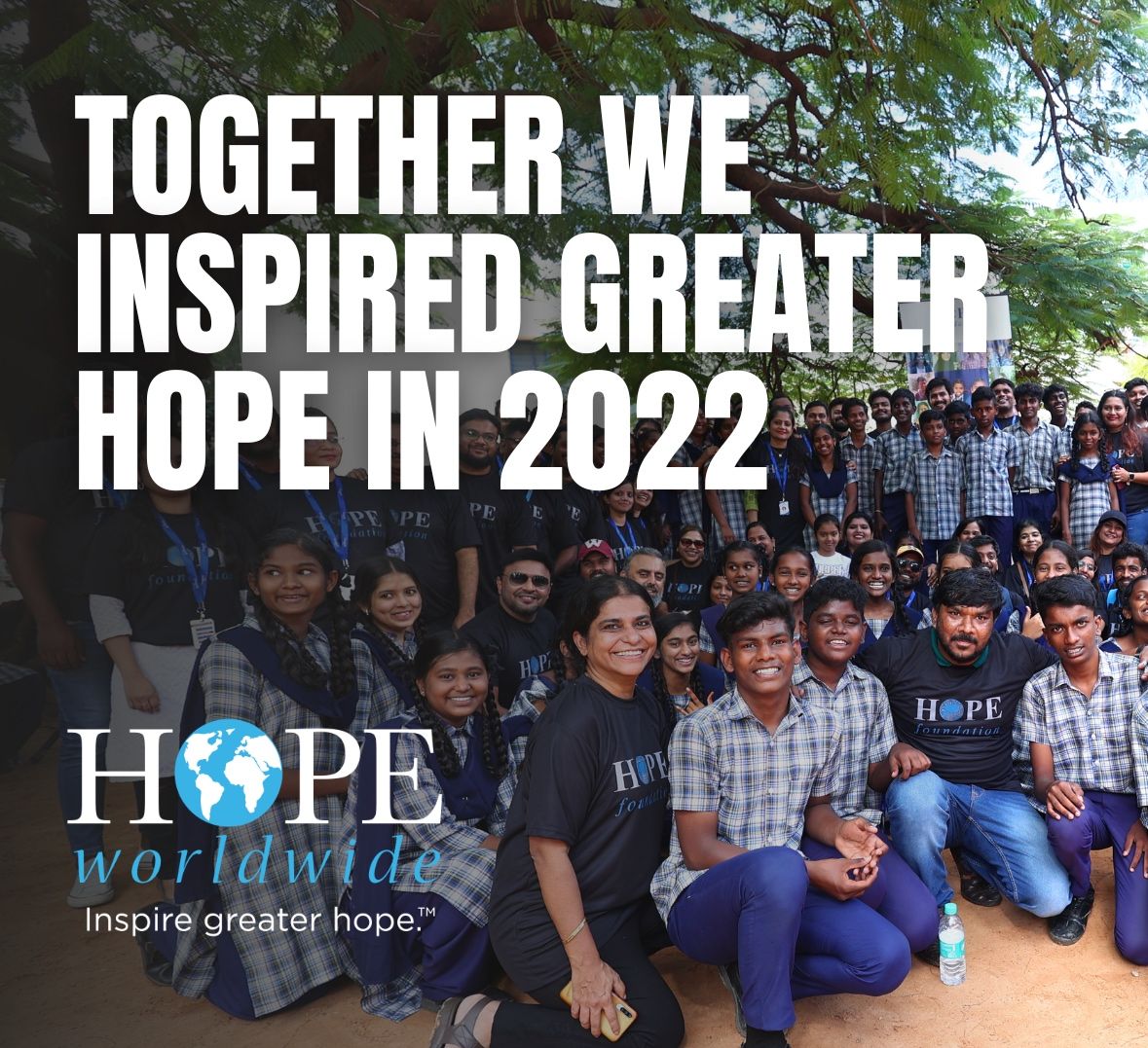Group photo of volunteers with “Together we inspired greater hope in 2022” and Hope Worldwide logo