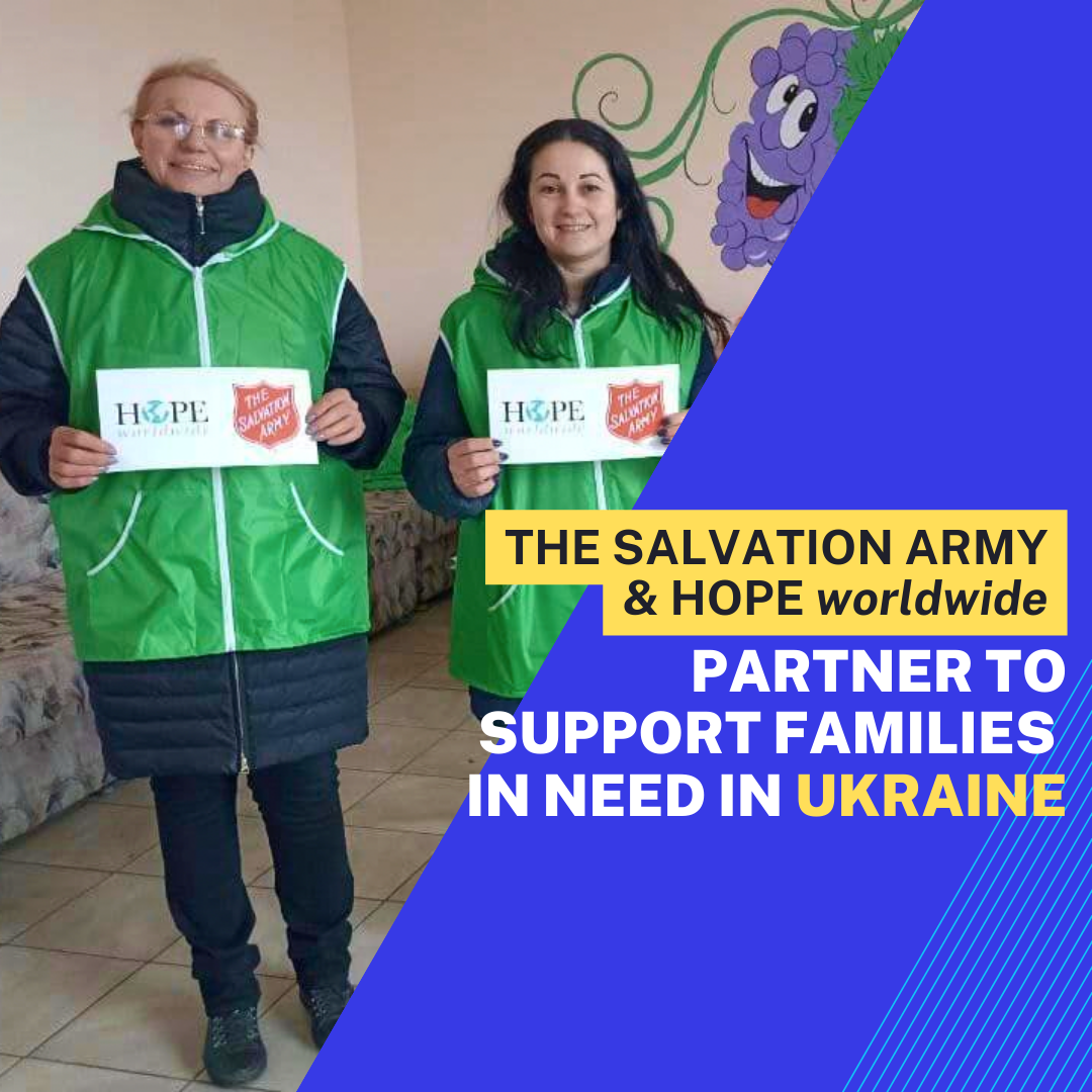 Two people in green vests hold signs supporting families in need in Ukraine, with Salvation Army and HOPE Worldwide text.