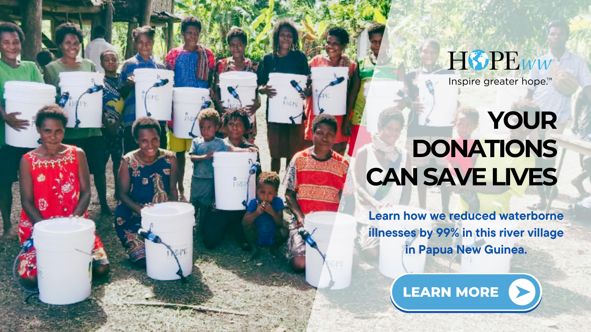 Group holding donated buckets outdoors beside a banner reading “Your donations can save lives.”