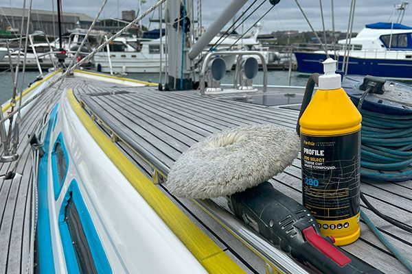 a bottle of polish is sitting on the deck of a boat .
