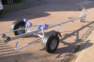 a boat trailer is parked on the side of the road