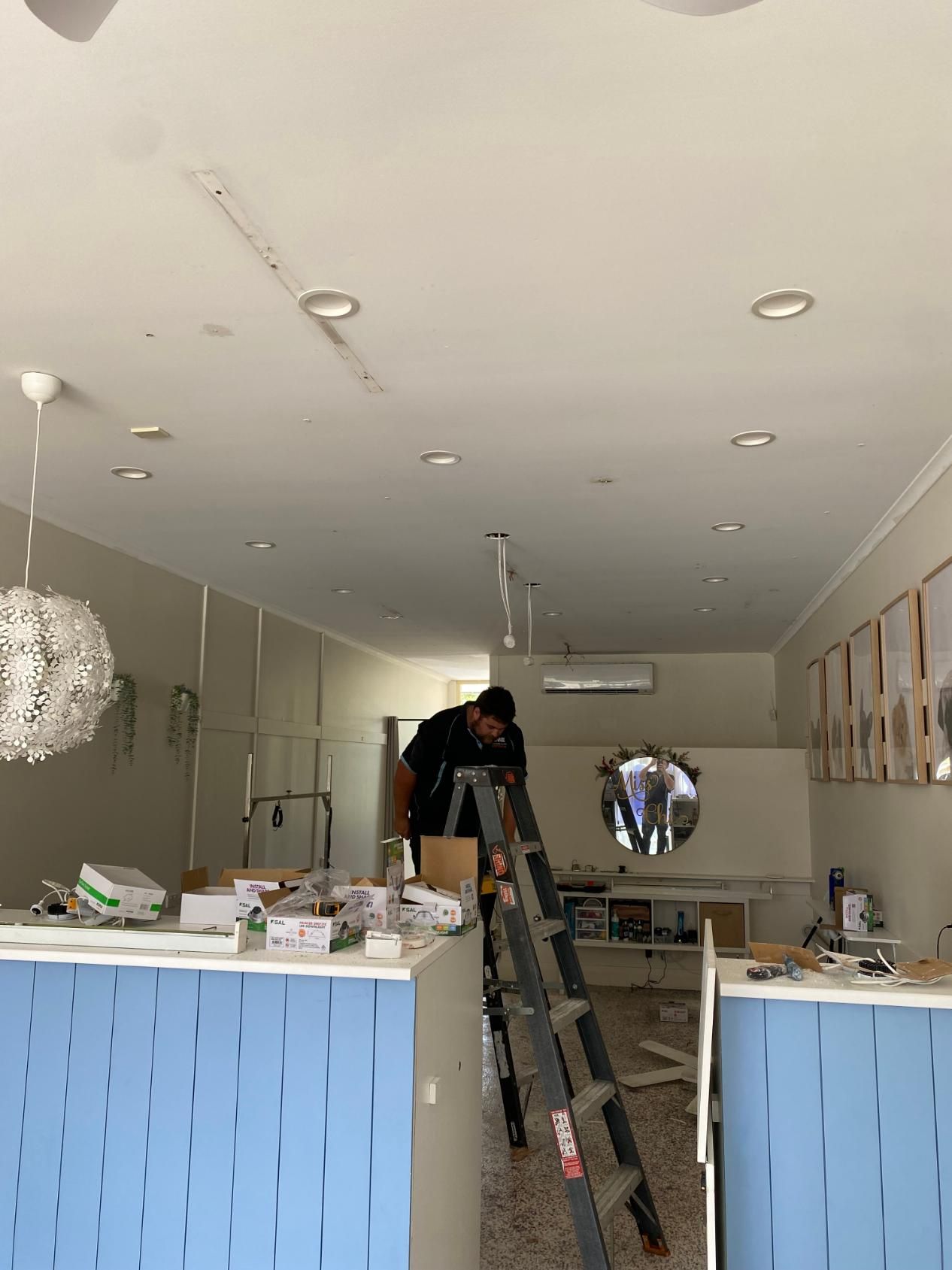 Man Standing on a Ladder in a Room — Brenden Wilson Electrical in Elimbah, QLD