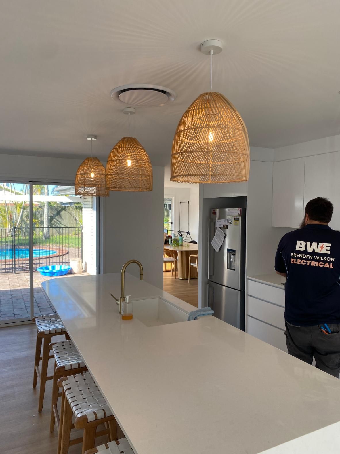 Man in a Shirt is Working in a Kitchen — Brenden Wilson Electrical in Mooloolah, QLD