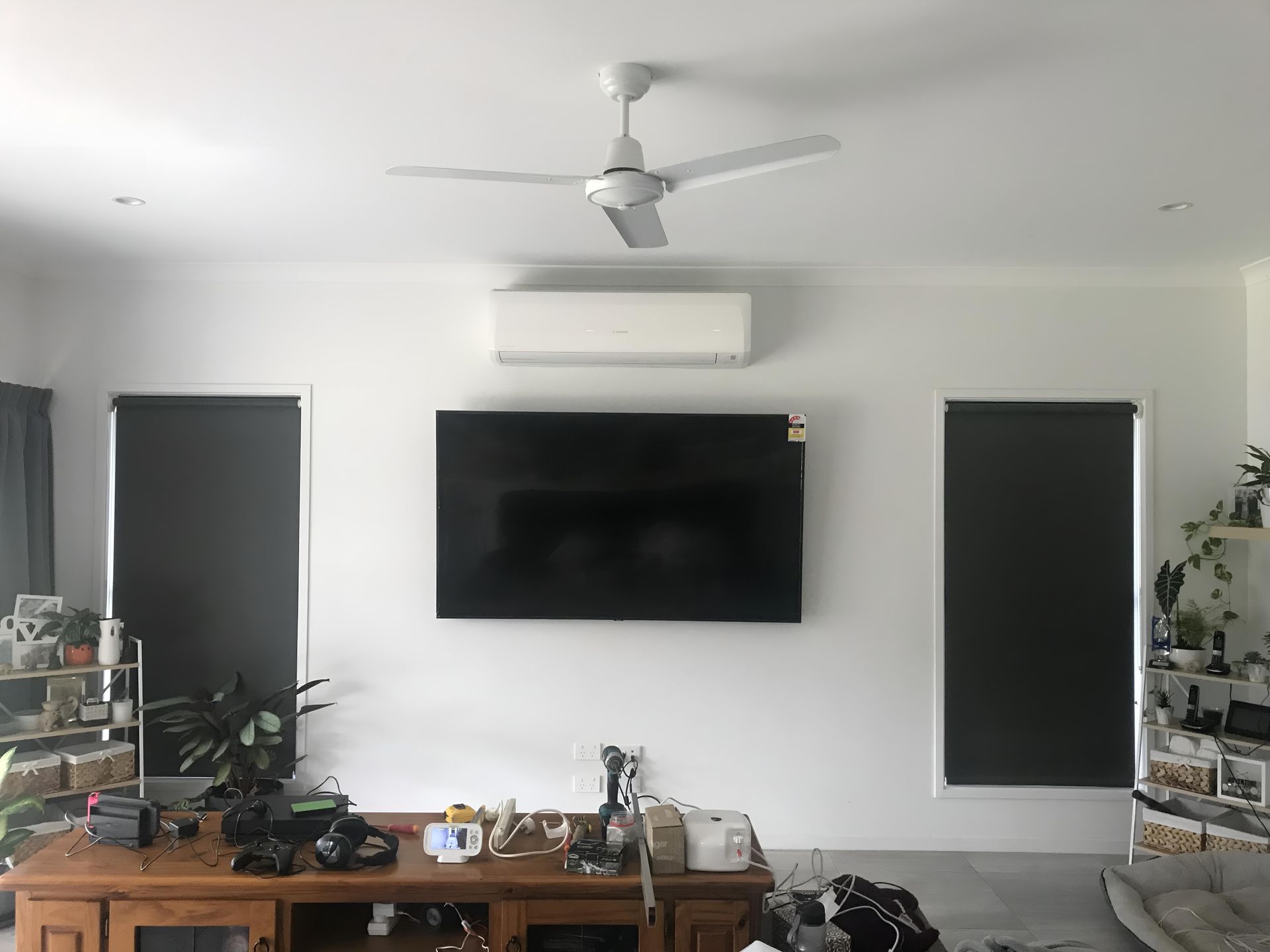 Living Room With a Ceiling Fan and a Flat Screen Tv — Brenden Wilson Electrical in Mooloolah, QLD