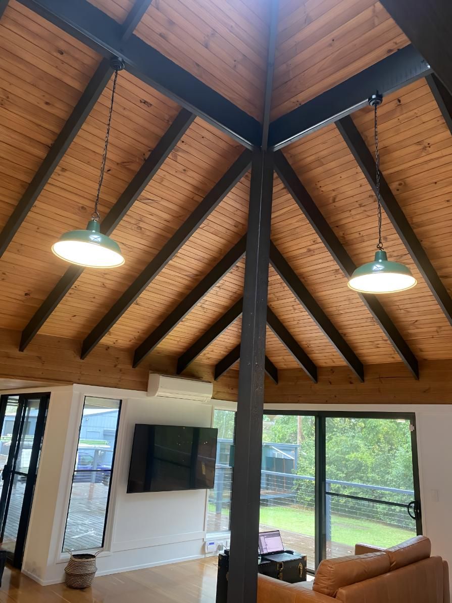 Living Room With a Wooden Ceiling and Two Lamps Hanging — Brenden Wilson Electrical in Beerwah, QLD