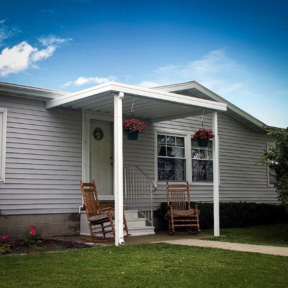 Small patio with cover and two seats — Cheyenne, WY — Frontier Siding Supply