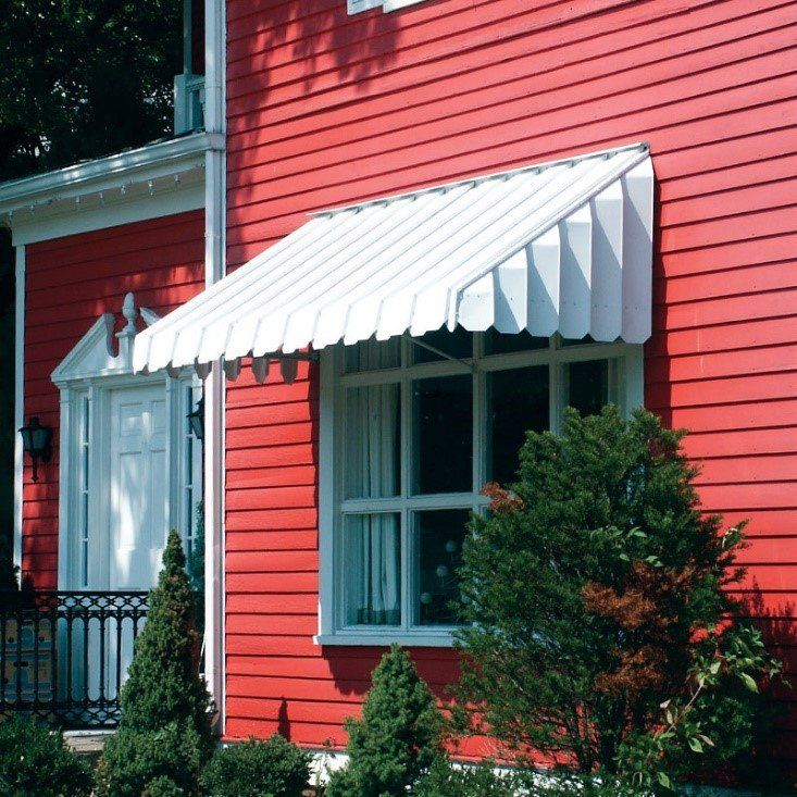 Red house with awning over window — Cheyenne, WY — Frontier Siding Supply
