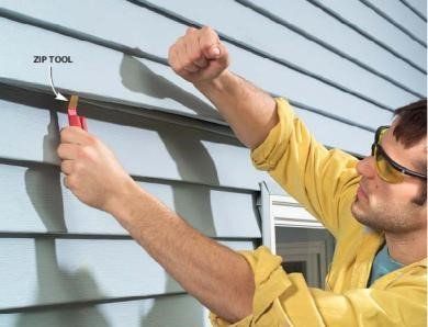 Man using zip tool on house — Cheyenne, WY — Frontier Siding Supply