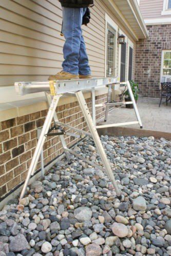 Man standing on small scaffold — Cheyenne, WY — Frontier Siding Supply
