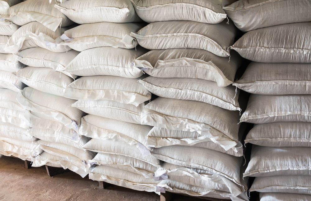 Stacked White Sacks Piled In Rows On A Warehouse Floor — Southern Protein Systems in Glenquarry, NSW