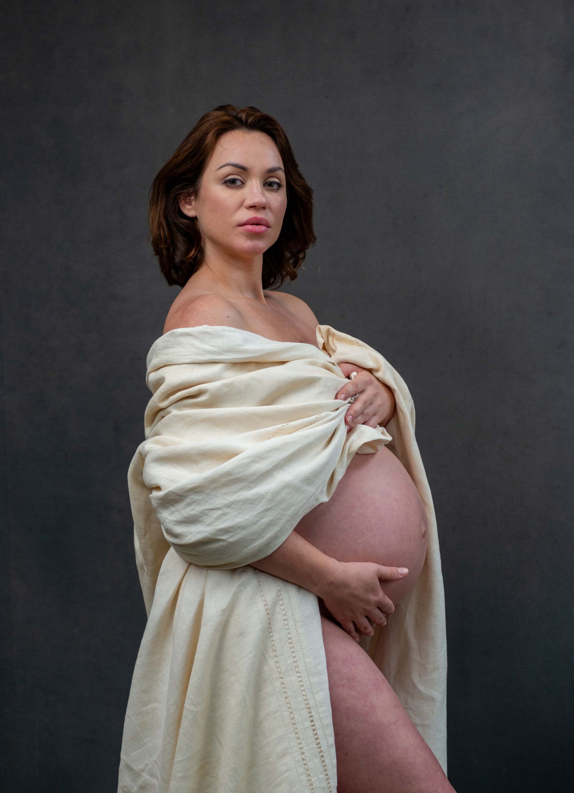 mother draped in cloth for pregnant maternity photo shoot in Asheville studio