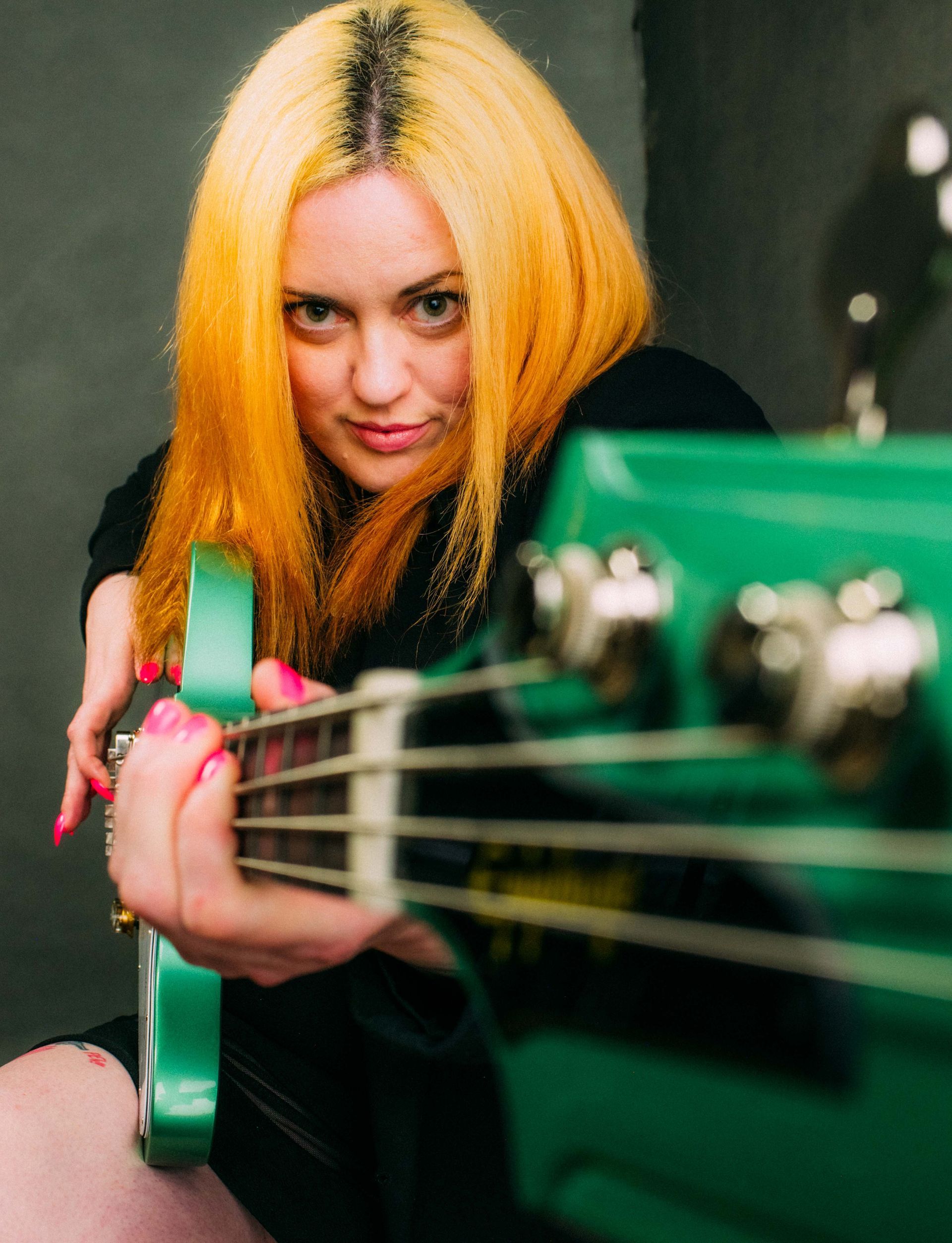 bass player with bass, portrait photographed at Echo Mountain Studios in Asheville, North Carolina by music photographer Sandlin Gaither 