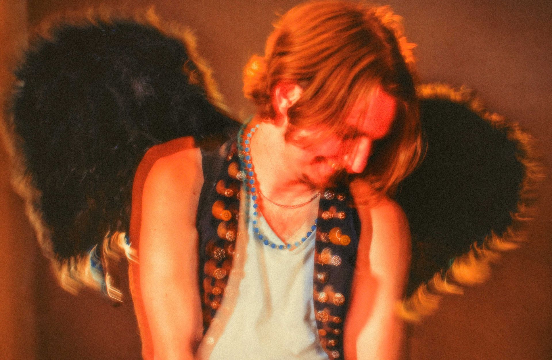 musician guitarist Andrew Scotchie poses with wings for portrait by Asheville North Carolina music photographer Sandlin Gaither 