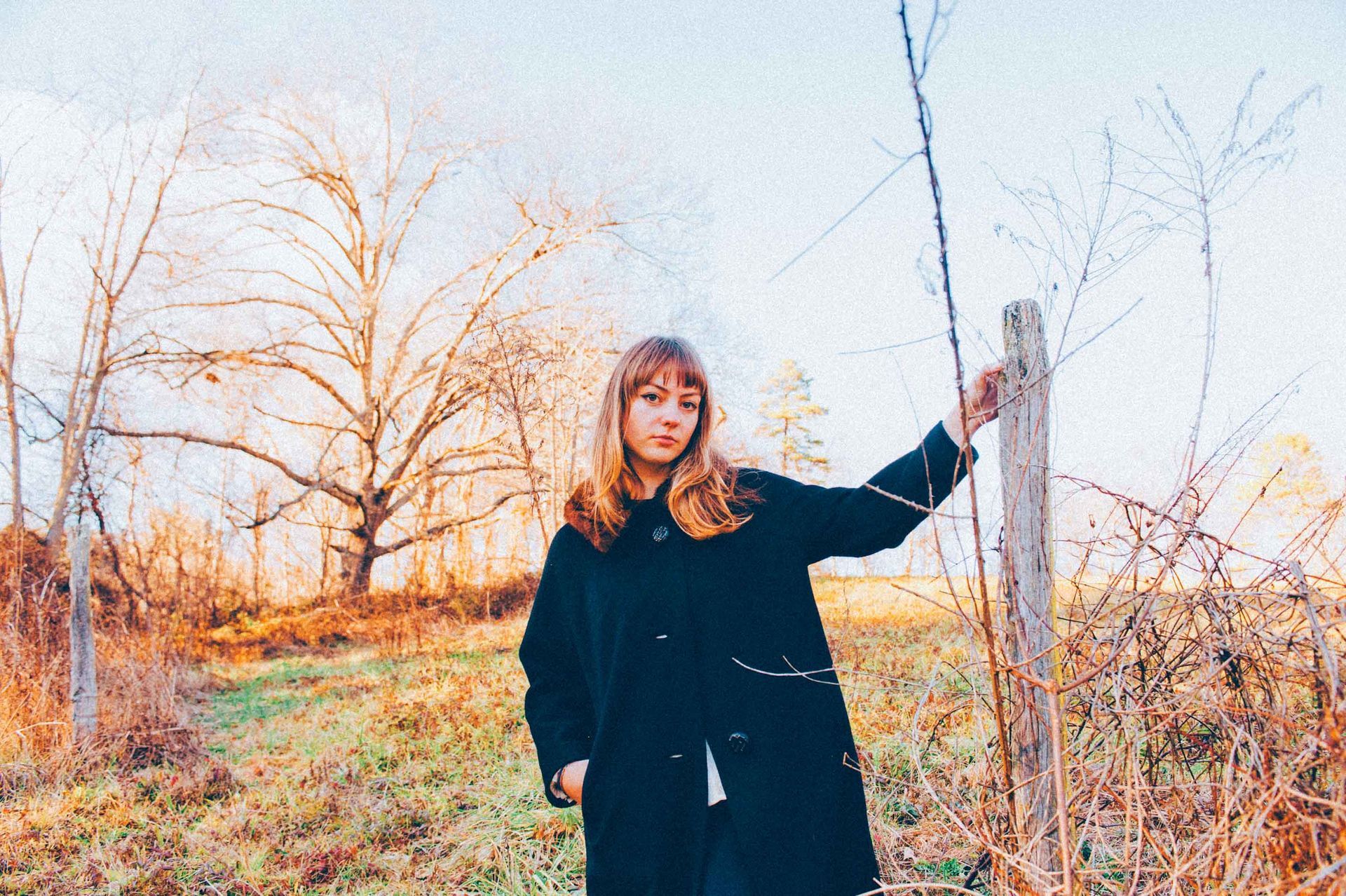 Angel Olsen poses for camera in West Asheville field