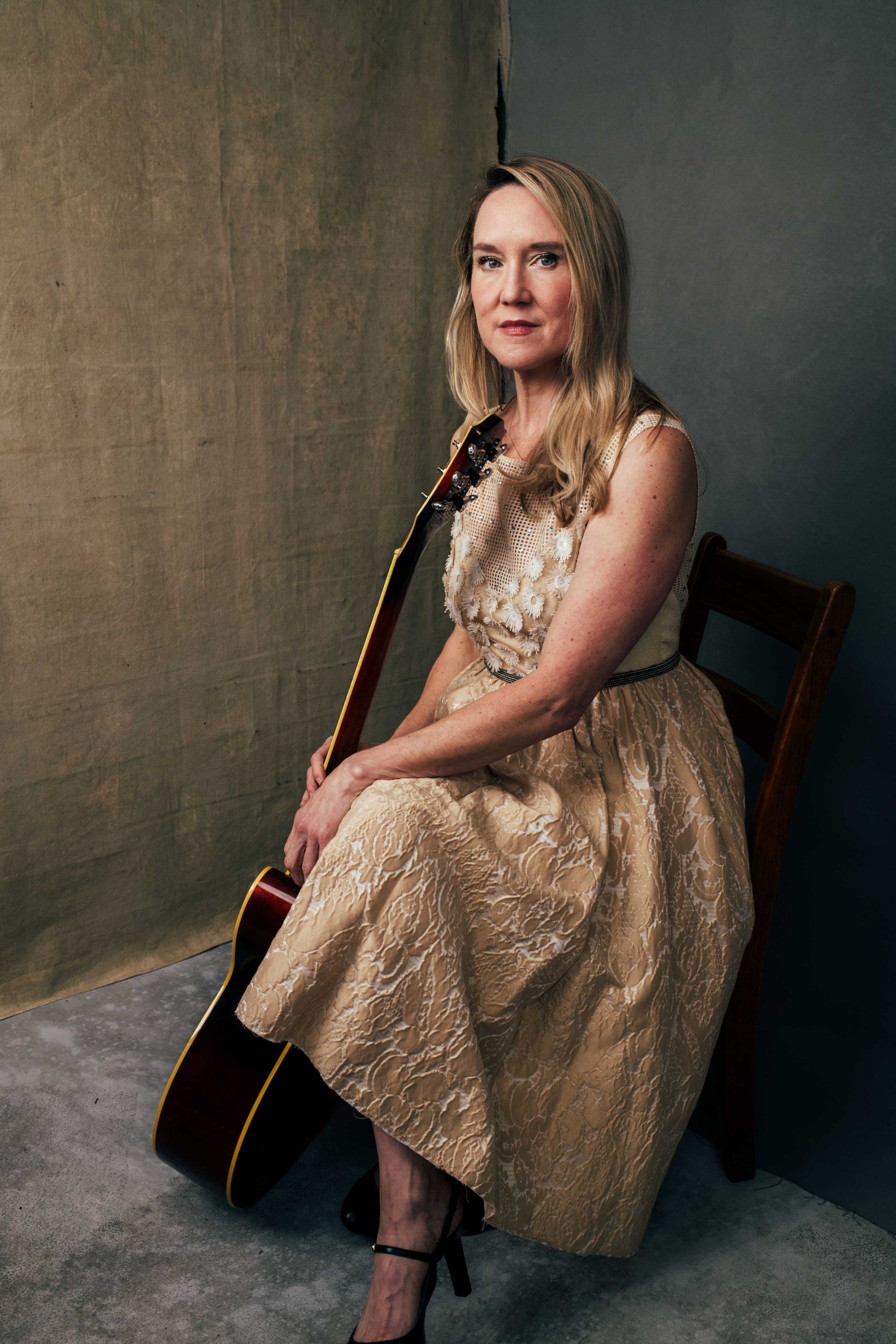 singer songwriter Angela Easterling posed in studio with acoustic guitar by Asheville North Carolina music photographer sandlin gaither 
