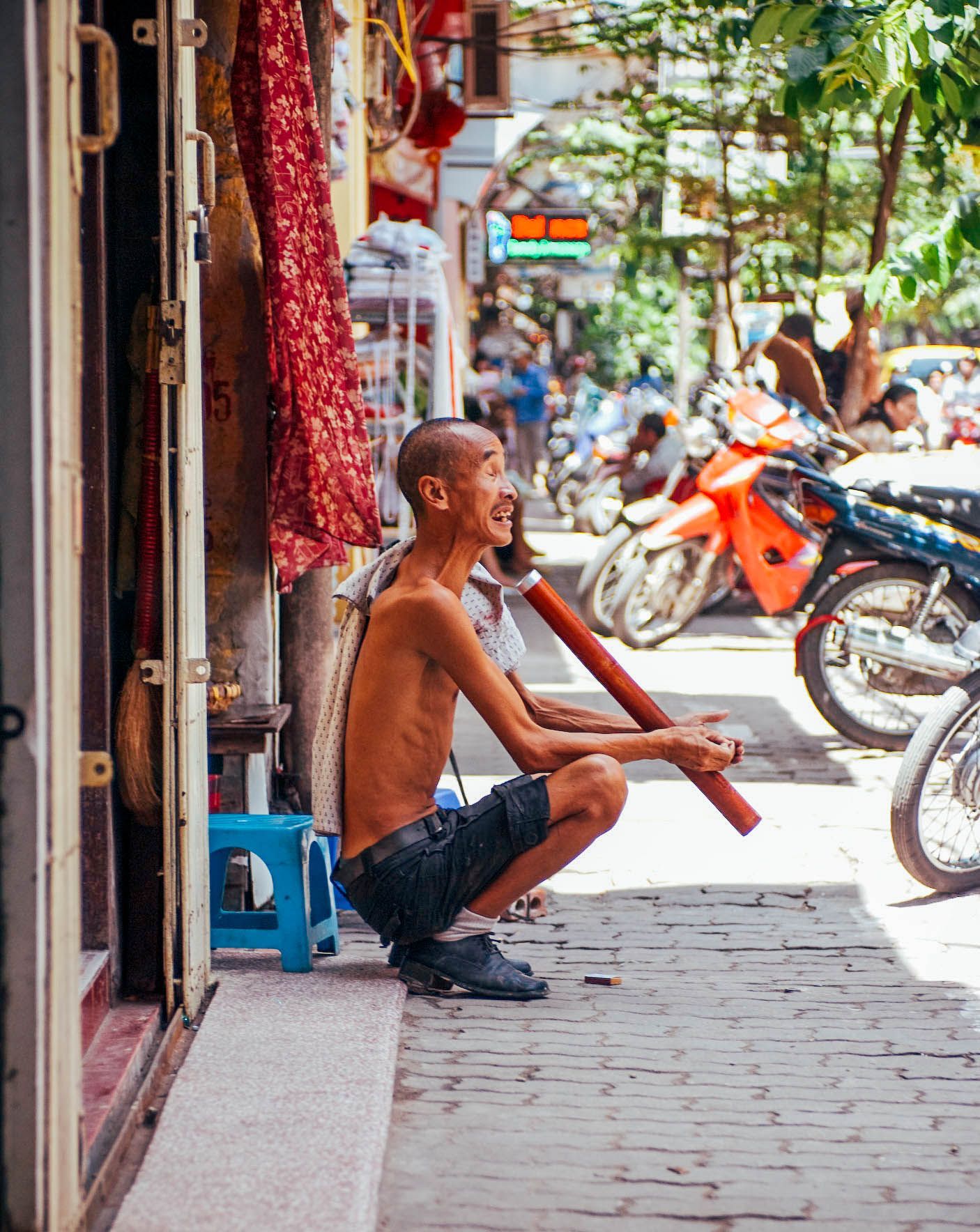 old man smoking bong on the street, Hanoi, Vietnam, small group travel and food photography tours with Sandlin Gaither Explorer's Club