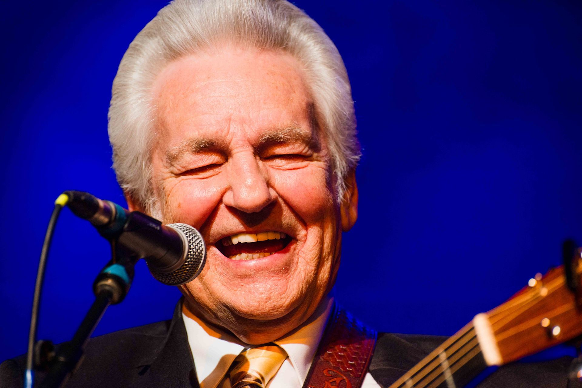 Bluegrass legend Del McCoury performs on stage at the Orange Peel in Asheville, North Carolina, with the Steep Canyon Rangers, photographed by music photographer Sandlin Gaither 