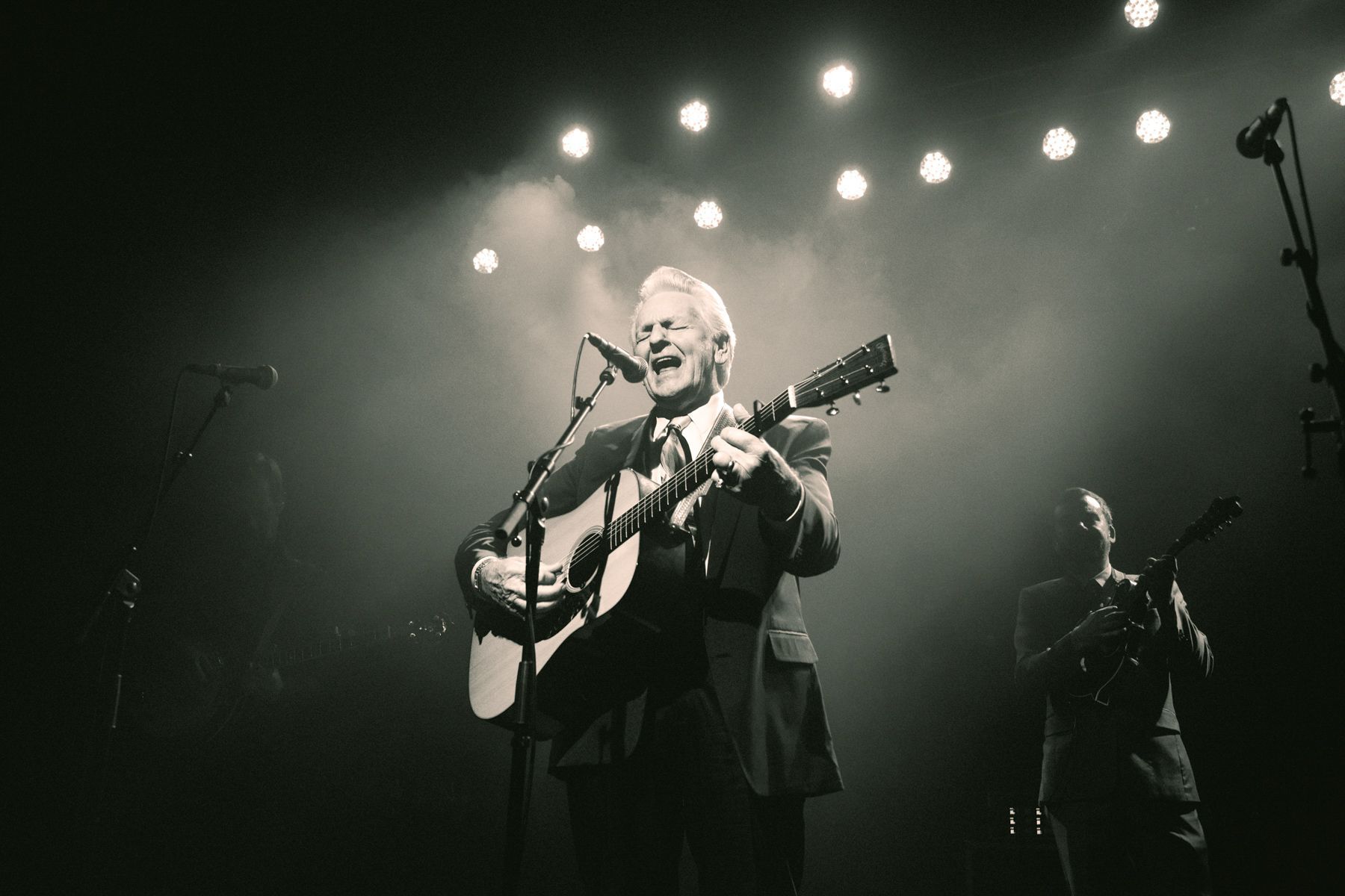 Bluegrass legend Del McCoury performs on stage at the Orange Peel in Asheville, North Carolina, with the Steep Canyon Rangers, photographed by music photographer Sandlin Gaither 