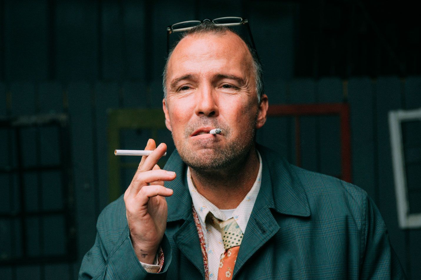 comedian Doug Stanhope smokes two cigarettes in a portrait by Asheville NC music photographer Sandlin Gaither at the Grey Eagle Music Hall