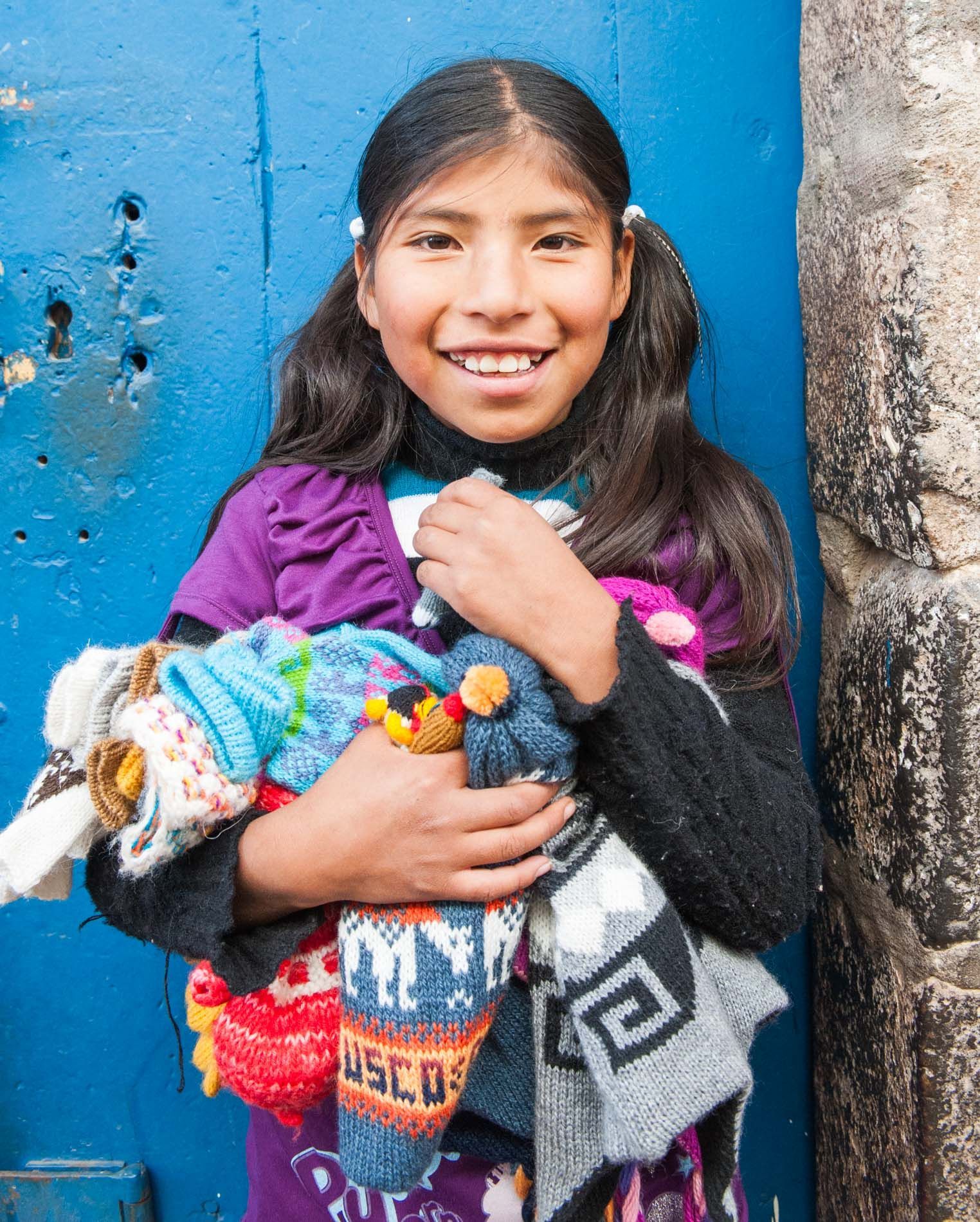 young peruvian girl poses for portrait, Cuzco, Peru, small group travel and food photography tours with Sandlin Gaither Explorer's Club