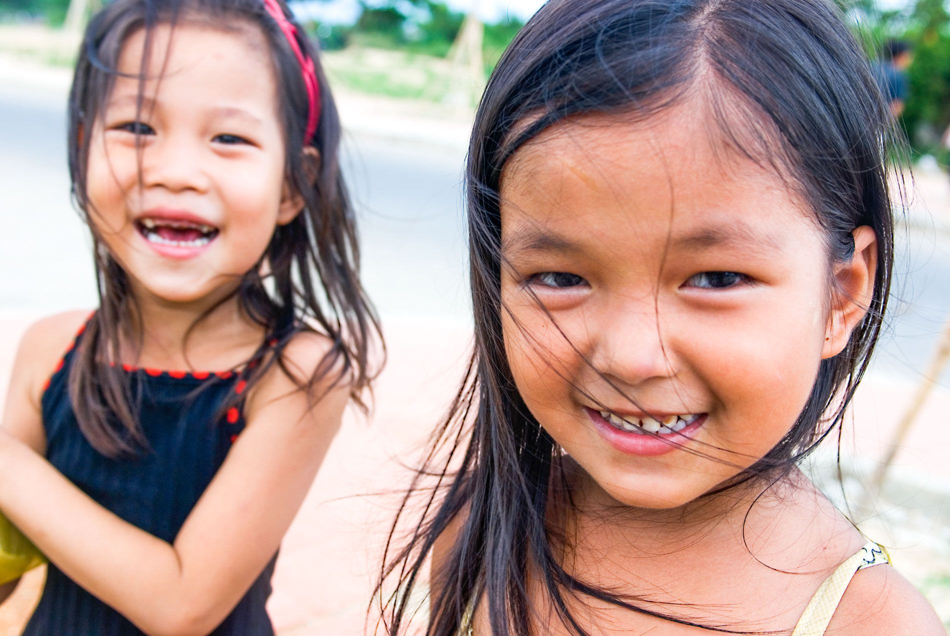 young girls smiling for camera, Hue, Vietnam, small group travel and food photography tours with Sandlin Gaither Explorer's Club
