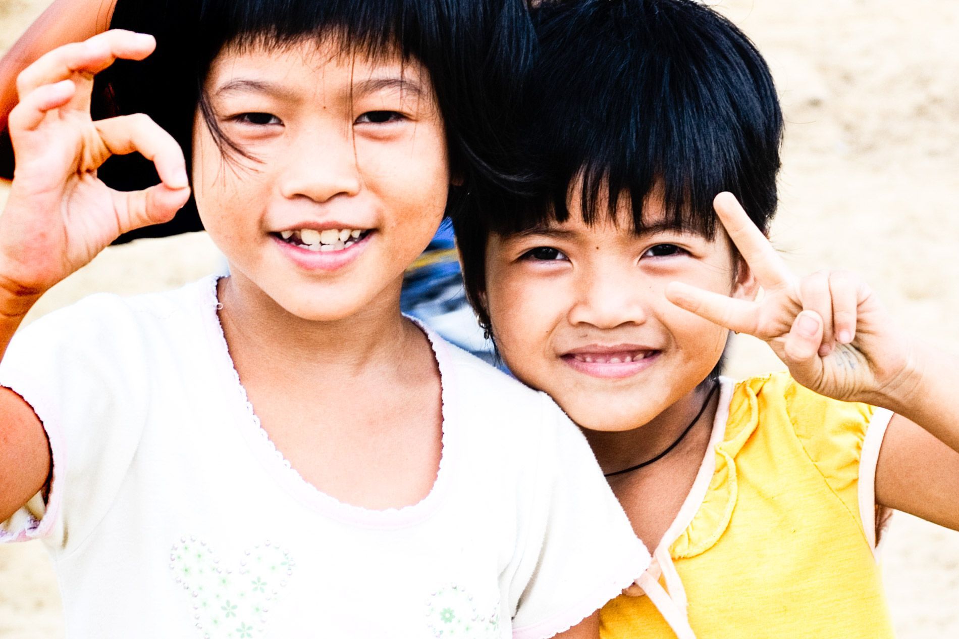 Vietnamese children playfully smiling for camera, Hue, small group travel and food photography tours with Sandlin Gaither Explorer's Club