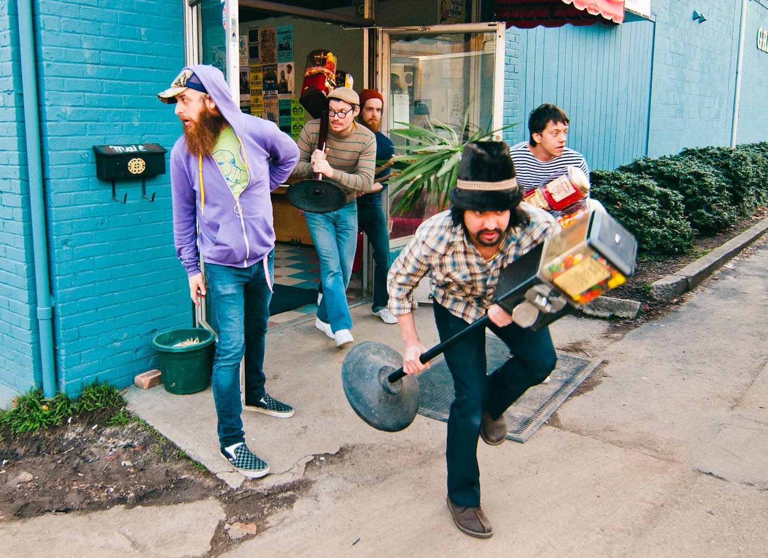 indie rock band Man Man poses for portrait stealing candy from the Grey Eagle Music Hall, photographed by Asheville, NC music photographer Sandlin Gaither 