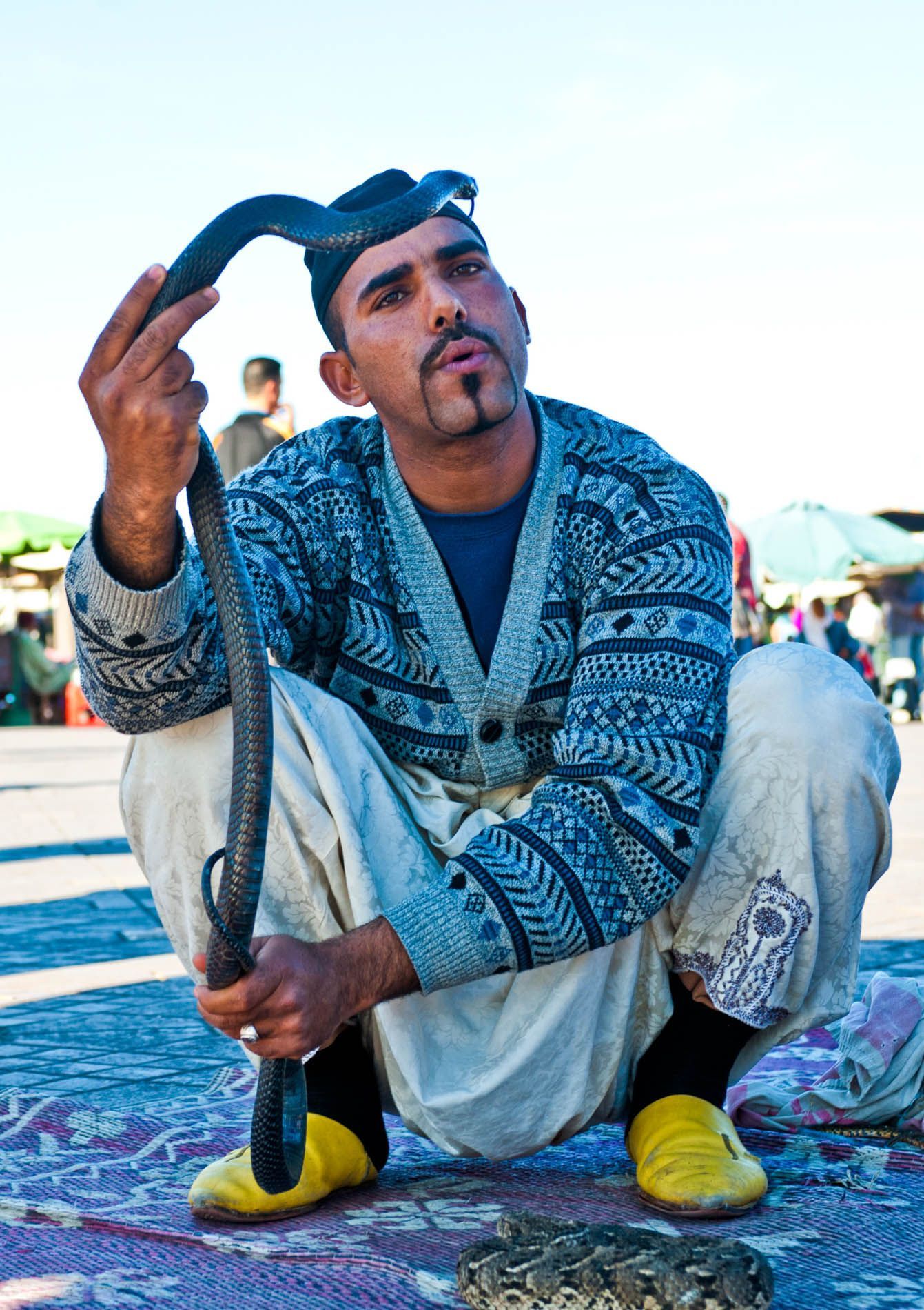 Cobra handler in Djemaa el-Fna market — image from Morocco photo adventure.