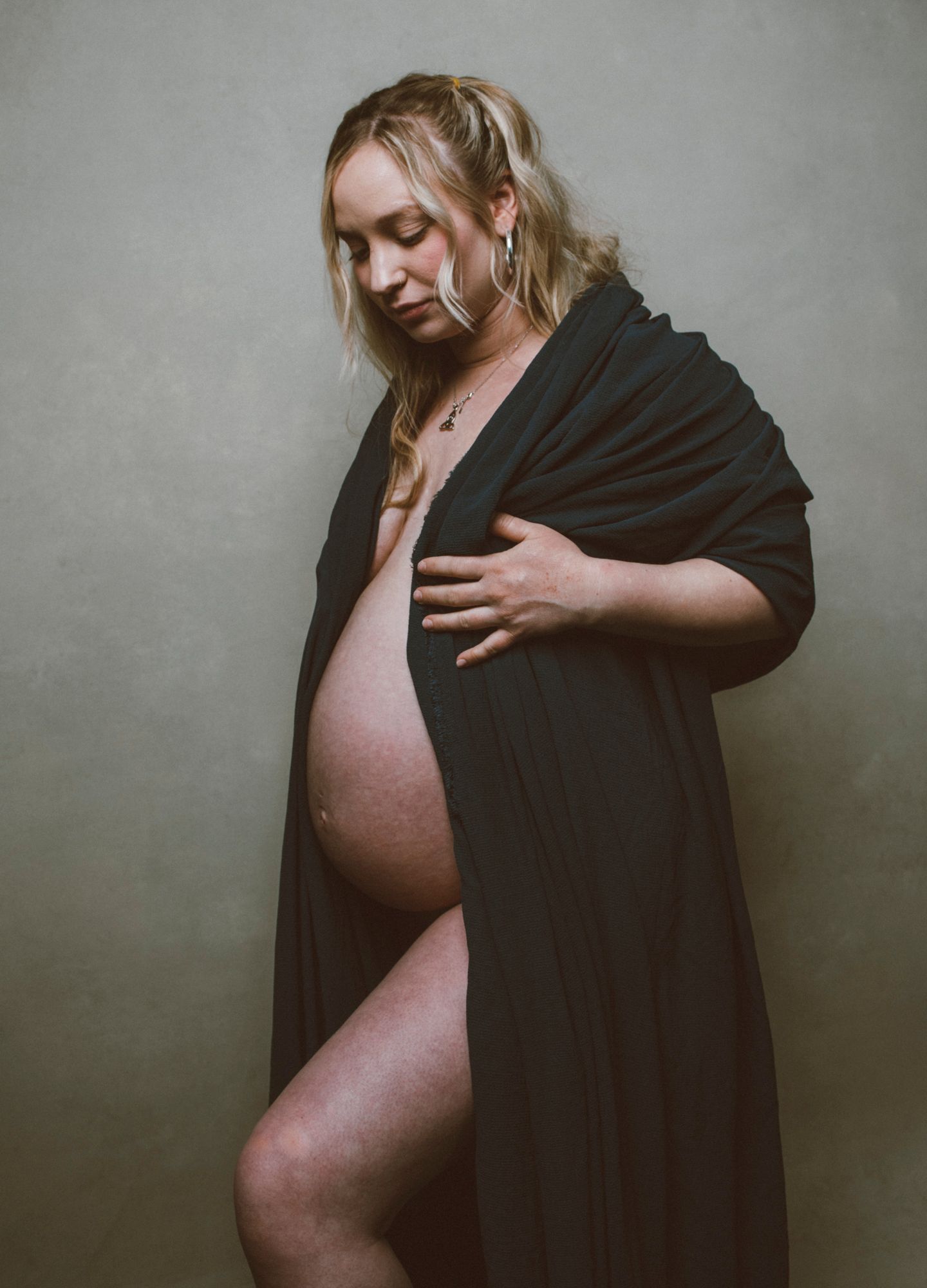 asheville pregnancy mother posed in photography studio for maternity session with body jewelry