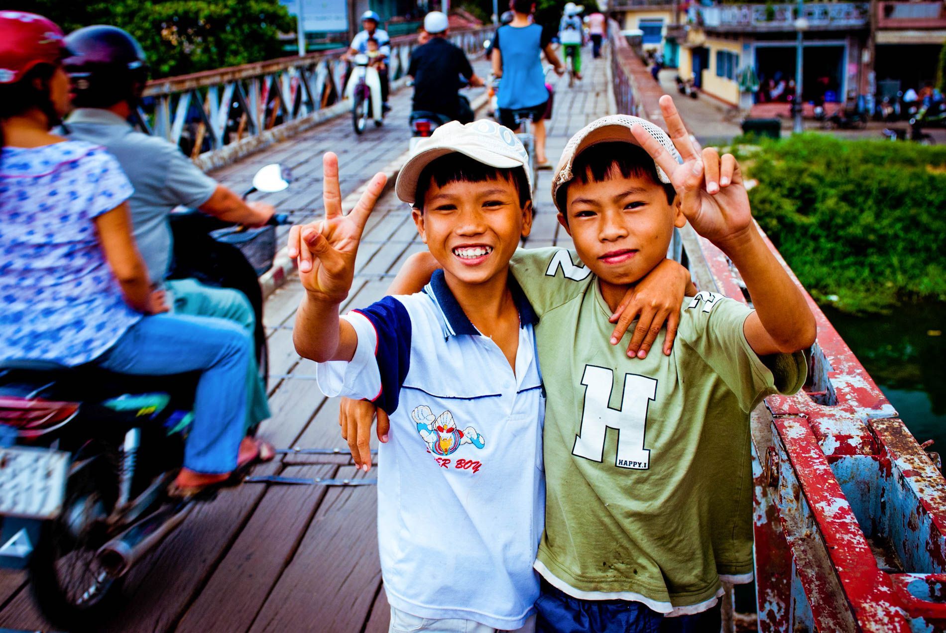 boys flashing peace signs, Hue, central Vietnam, small group travel and food photography tours with Sandlin Gaither Explorer's Club