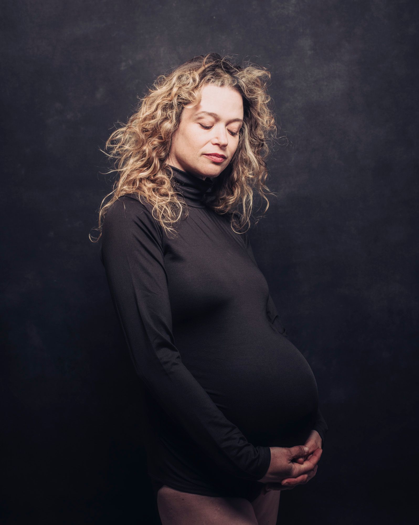 pregnant mother in maternity photography session in funky, trendy modern pose
