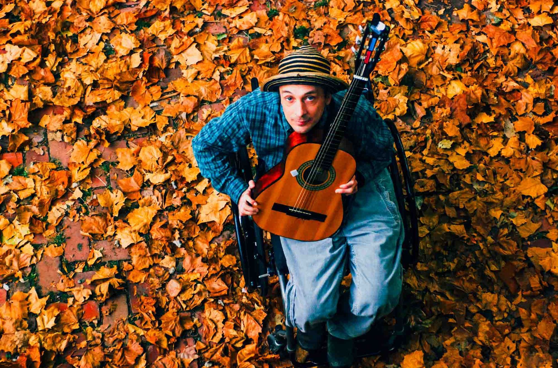 Vic Chesnutt portrait in leaves in Asheville, NC, photographed by music photographer sandlin gaither at the Grey Eagle Music Hall