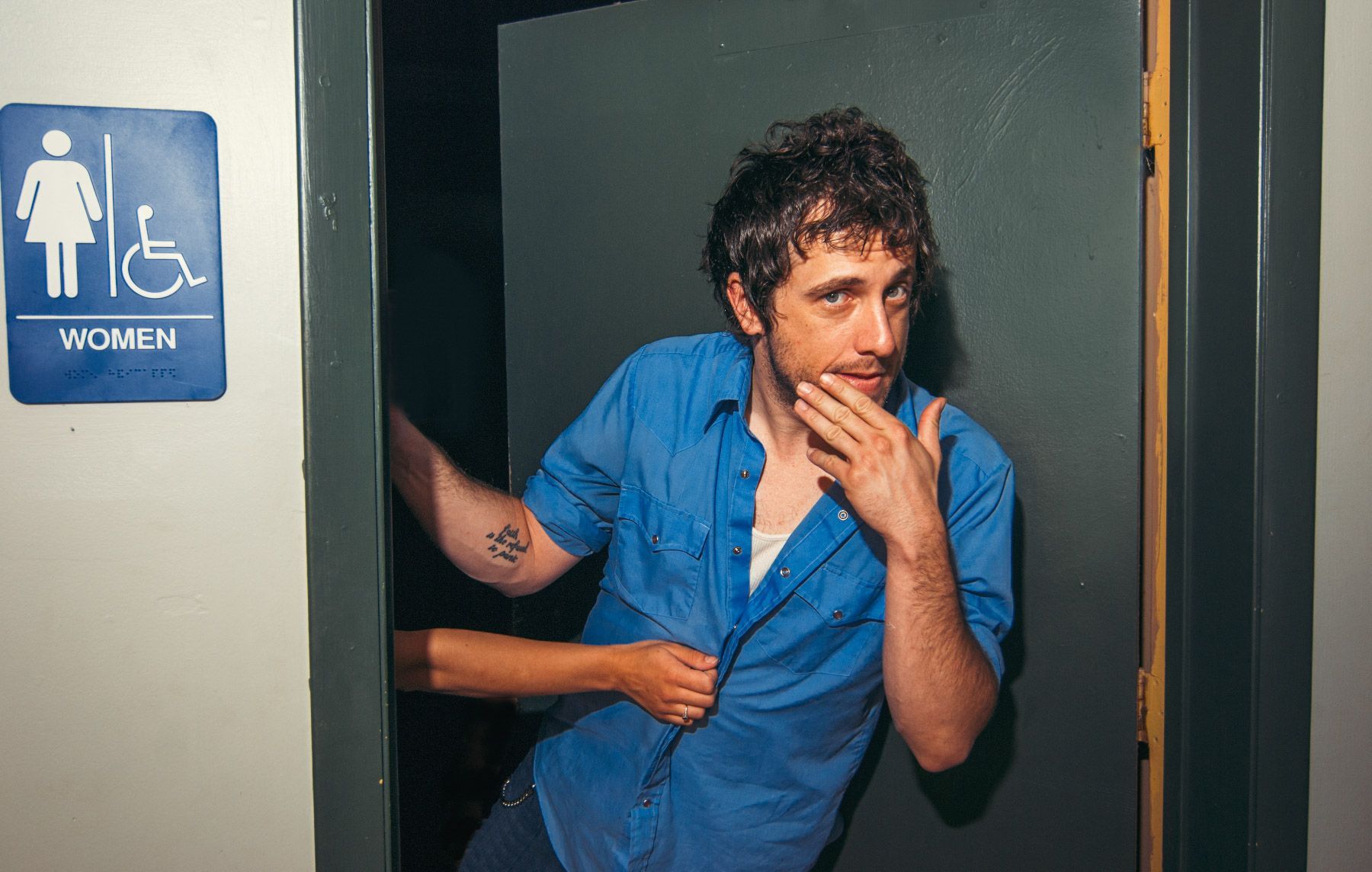 singer songwriter Will Hoge posing in the women's restroom of the Grey Eagle Music hall, photographed by asheville music photographer Sandlin Gaither