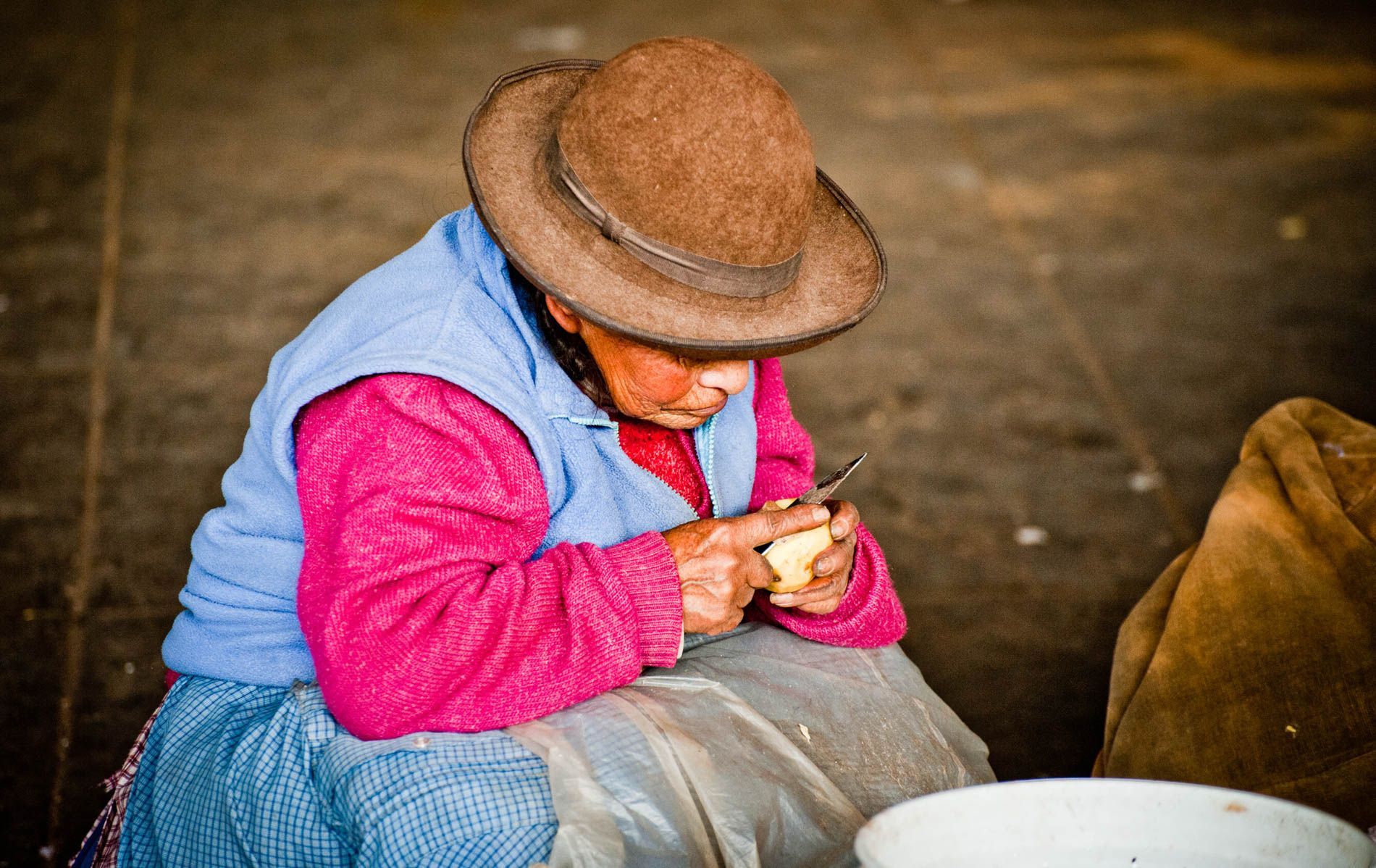 Peruvian woman carving potatoes in the market, Cuzco, Peru, small group travel and food photography tours with Sandlin Gaither Explorer's Club