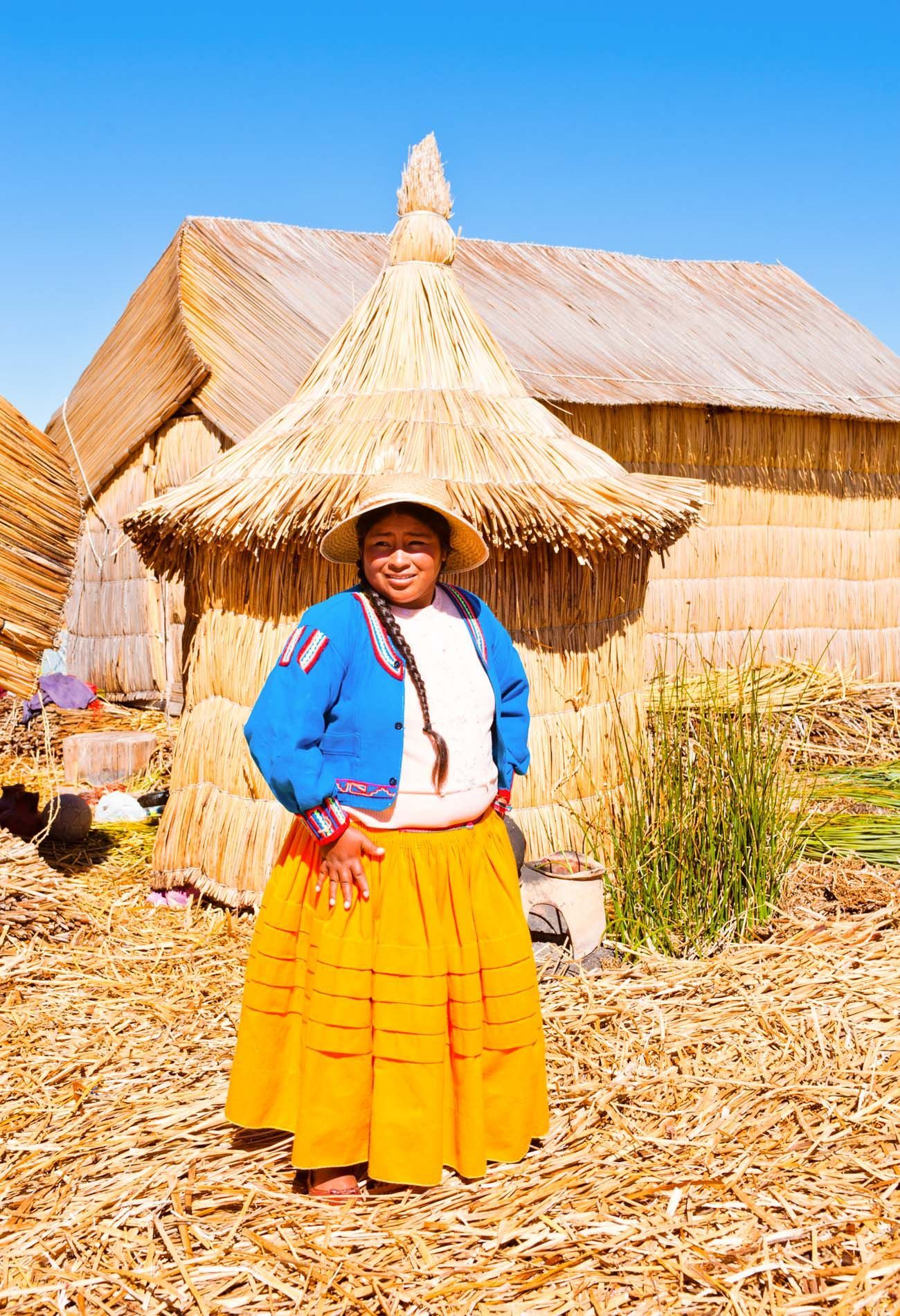woman poses for camera on Uros Islands, Lake Titicaca, Peru, small group travel and food photography tours with Sandlin Gaither Explorer's Club
