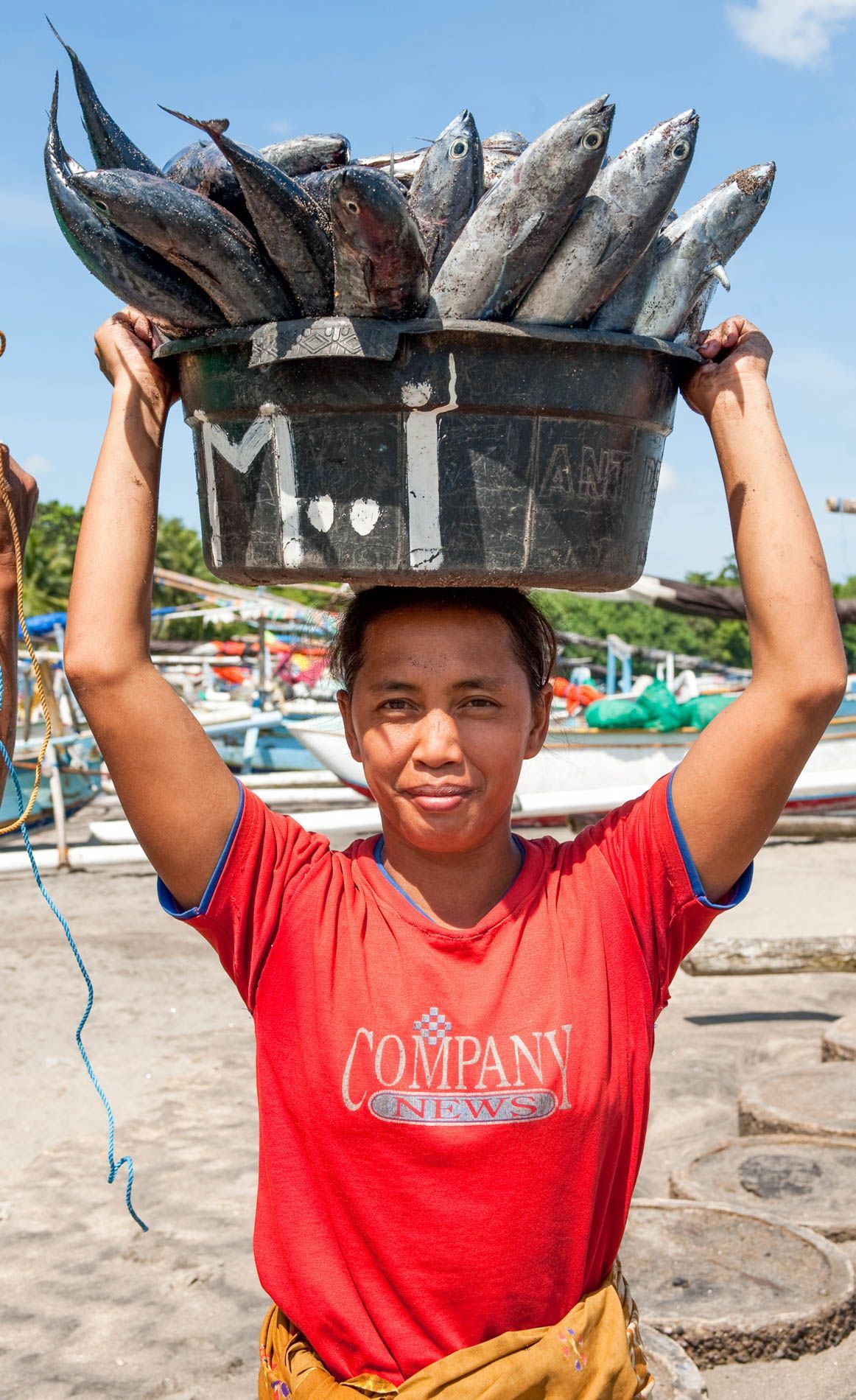 woman with fish basket, Sengiggi, Indonesia, small group travel and food photography tours with Sandlin Gaither Explorer's Club