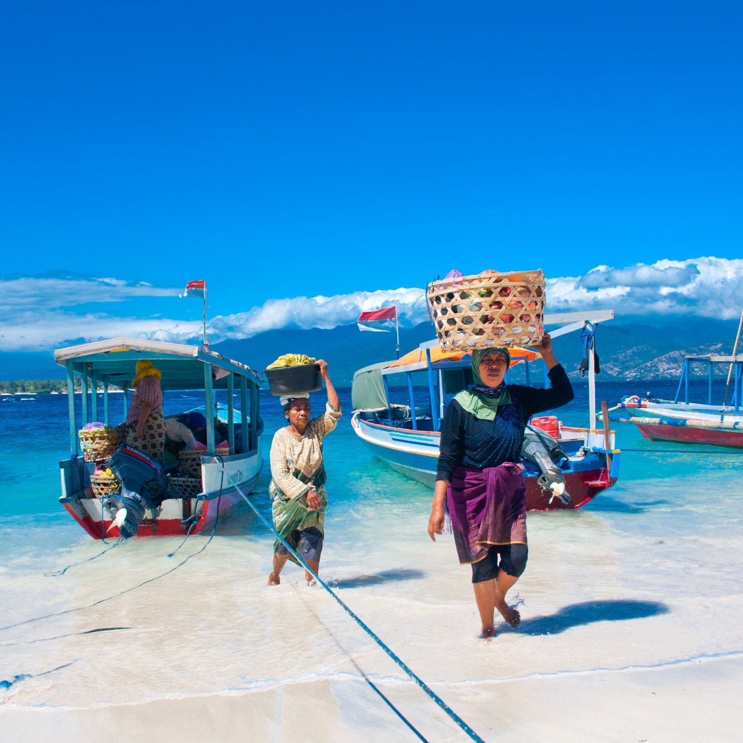 Women unloading supplies from boats — Gili Trawangan travel photography.
