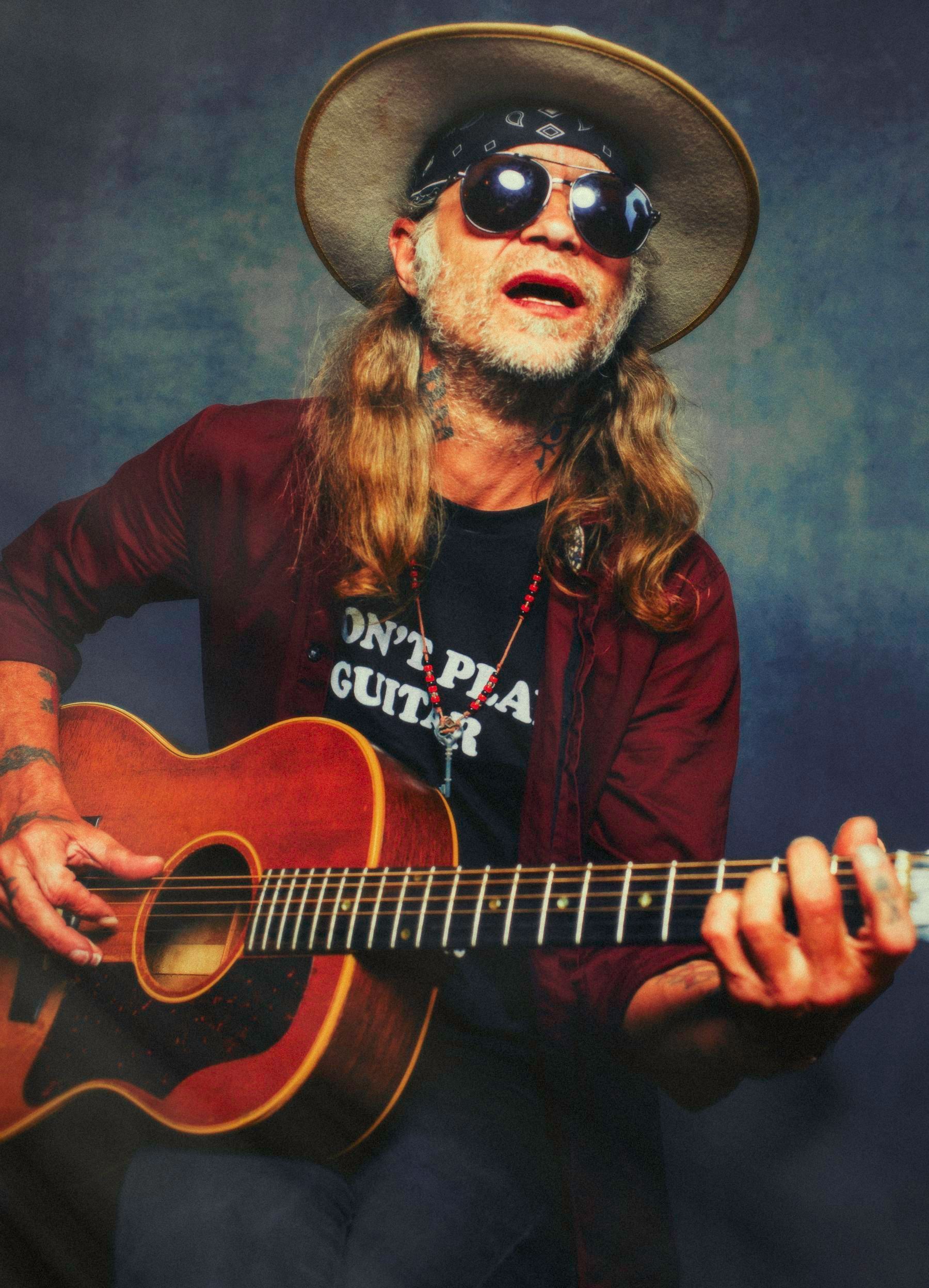 musician guitarist Woody Wood poses with acoustic guitar for portrait by Asheville North Carolina music photographer Sandlin Gaither at Echo Mountain Studios, 2026